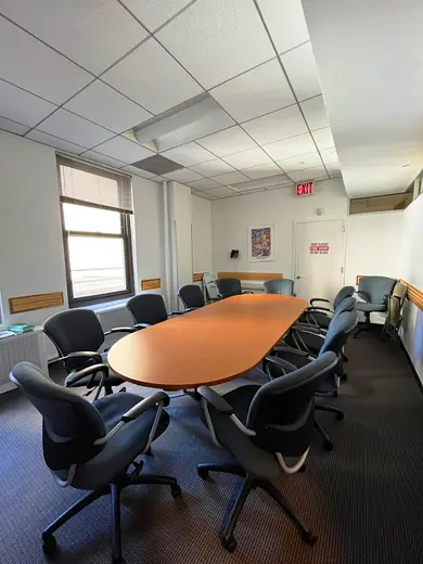 Conference room with oval table at Parallax Center Inc., a partial hospitalization program in Bronx.